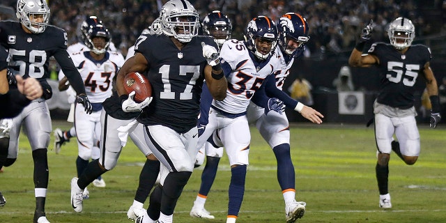Oakland Raiders' Dwayne Harris (17) returns a punt for a touchdown against the Denver Broncos during the first half of an NFL football game in Oakland, Calif., Monday, Dec. 24, 2018.
