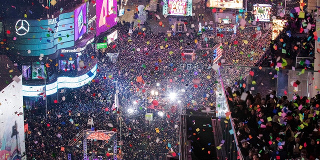 FILE - In this Jan. 1, 2017 file photo, revelers celebrate the new year as confetti flies over New York's Times Square. Year after year, people watching New York City's New Year's Eve celebration are told by city dignitaries and TV personalities that they are watching a million people gathered in Times Square. The AP asks experts whether it is actually possible to fit that many people into the viewing areas. (AP Photo/Mary Altaffer, File)