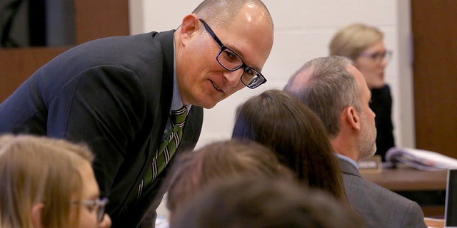 High school teacher Peter Vlaming chats at a West Point School Board hearing in West Point, Va., Dec. 6, 2018. The board voted unanimously to dismiss Vlaming.