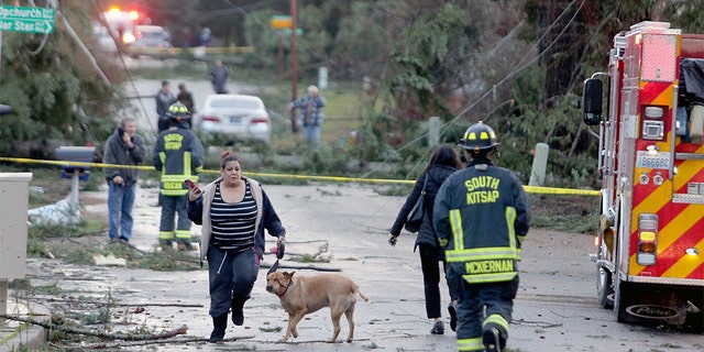 Residents and emergency personnel on Harris Road in Port Orchard, Wash., on Tuesday, Dec. 18, 2018, after a tornado touched down. (Larry Steagall/Kitsap Sun via AP)