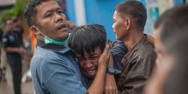 A man reacts after identifying his relative among the bodies of tsunami victims in Carita, Indonesia, Sunday. (AP Photo/Fauzy Chaniago)