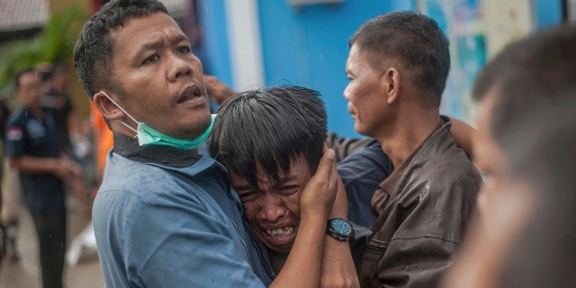 A man reacts after identifying his relative among the bodies of tsunami victims in Carita, Indonesia, Sunday. (AP Photo/Fauzy Chaniago)