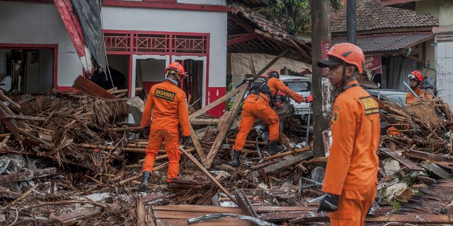 Rescuers search for tsunami victims in Carita, Indonesia, Sunday. (AP Photo/Fauzy Chaniago)