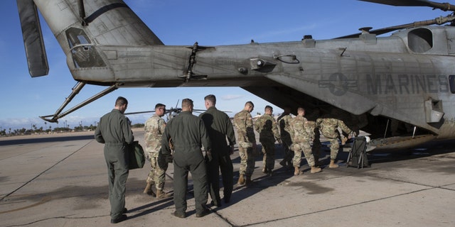 U.S. Soldiers with 19th Engineering Battalion, Special Purpose Marine Air-Ground Task Force 7 (SPMAGTF-7), and U.S. Marines with Marine Heavy Helicopter Squadron 446, SPMAGTF-7, board a CH-53E Super Stallion at Naval Air Facility El Centro, Nov. 30, 2018.
