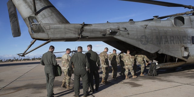 U.S. Soldiers with 19th Engineering Battalion, Special Purpose Marine Air-Ground Task Force 7 (SPMAGTF-7), and U.S. Marines with Marine Heavy Helicopter Squadron 446, SPMAGTF-7, board a CH-53E Super Stallion at Naval Air Facility El Centro, Nov. 30, 2018.