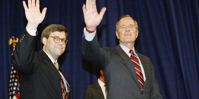 President George Herbert Walker Bush and then-Attorney General Bill Barr wave from a dais.
