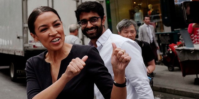 FILE - In this Wednesday June 27, 2018, file photo, Alexandria Ocasio-Cortez, left, the winner of New York's Democratic Congressional primary, greets supporters following her victory, along with Saikat Chakrabarti, founder of Justice Democrats and senior adviser for her campaign. (AP Photo/Mark Lennihan, File)