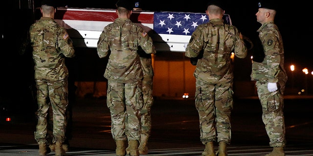 A U.S. Army team prepares to place a transfer case containing the remains of Capt. Andrew P. Ross into a vehicle at Dover Air Force Base, in Delaware, Friday. He was one of the four victims of the Afghanistan roadside bomb attack.