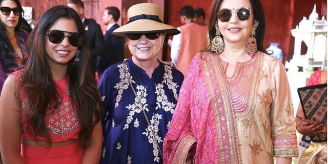 Hillary Clinton posing with bride Isha Ambani and mother-of-the-bride Nita Ambani. Huma Abedine is seen in the background.