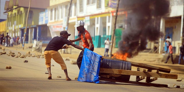 Protesters set up a barricade in the Eastern Congolese city of Beni on Thursday. Police in eastern Congo have fired live ammunition and tear gas to disperse dozens of people protesting a presidential election delay that means more than 1 million votes will not count. 