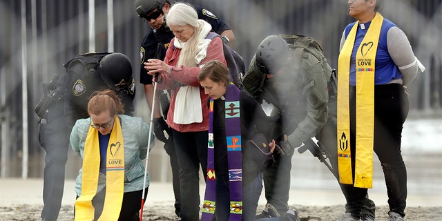 Women detained during the protest. (AP Photo/Gregory Bull)