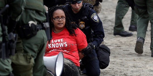 Protesters detained near the border with Tijuana, Mexico, on Monday. (AP Photo/Gregory Bull)
