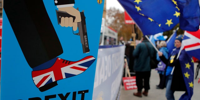 Protestors demonstrate opposite Parliament against Britain's Brexit split from Europe, in London, Thursday, Dec. 6, 2018.