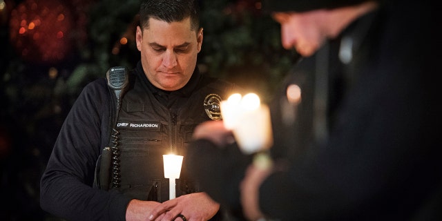 In this Dec. 28, 2018, photo, Newman Police Chief Randy Richardson and hundreds of people attend a vigil in memory of police Cpl. Ronil Singh during a candlelight vigil in downtown Newman, Calif.