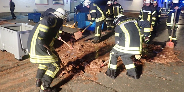 Spilt chocolate is cleared from a road in Werl, Germany December 10, 2018 in this picture obtained from social media. Picture taken December 10, 2018.