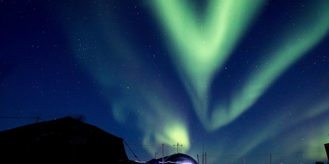 FILE - In this March 9, 2018, file photo provided by the U.S. Navy, the aurora borealis displays above Ice Camp Skate in the Beaufort Sea during Ice Exercise (ICEX) 2018. Scientists are seeing surprising melting in Earth's polar regions at times they don't expect, like winter, and in places they don't expect, like eastern Antarctica. (MC 2nd Class Micheal H. Lee/U.S. Navy via AP, File)