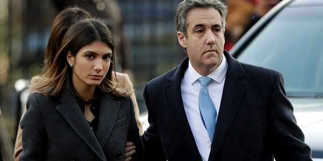 Michael Cohen, right, President Donald Trump's former lawyer, arrives at federal court for his sentencing for dodging taxes, lying to Congress and violating campaign finance laws in New York on Wednesday, Dec. 12, 2018. (AP Photo/Julio Cortez)