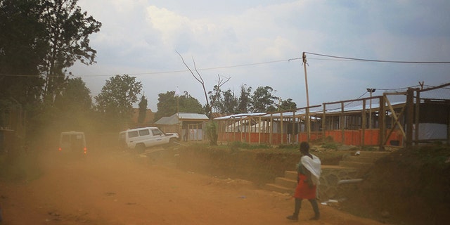 Ambulances drive into an attacked ebola treatment center during protest by demonstrators over their exclusion from the presidential election in Beni, Democratic Republic of the Congo.