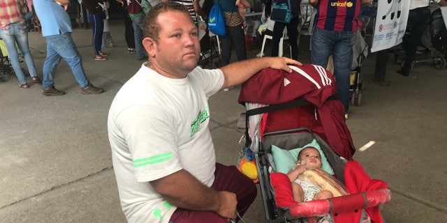 Alberto Camacho, 35 with his five-month-old daughter crosses from Venezuela to Colombia to find healthcare and vaccines.