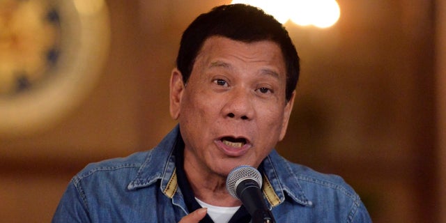 Philippine President Rodrigo Duterte gestures while speaking during a late-night news conference at the presidential palace in Manila, Philippines.