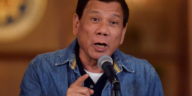 Philippine President Rodrigo Duterte gestures while speaking during a late-night news conference at the presidential palace in Manila, Philippines.