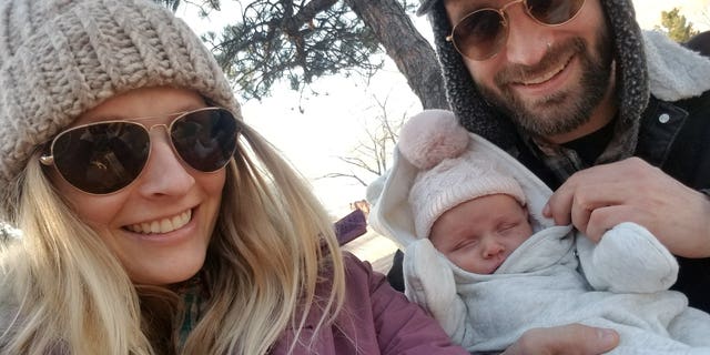 Taylor Smith, pictured with his baby Hazel and fiance Michelle Arnold, did not realize he was colorblind until he failed a test on Facebook.