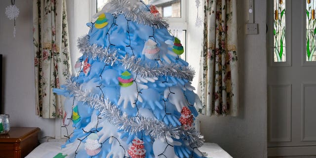 Along with surgical gloves, the tree is decorated with cupcake liners and candy wrappers.