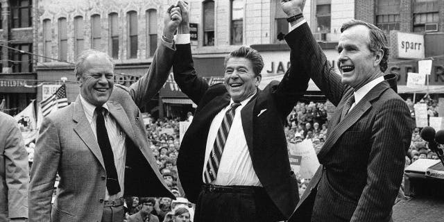 Former President Gerald Ford, left, lends his support to Republican presidential candidate Ronald Reagan, center, and his running mate George H.W. Bush, in Peoria, Illinois.