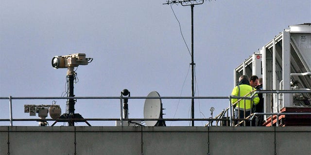 Counter-drone equipment is deployed on a rooftop at Gatwick.