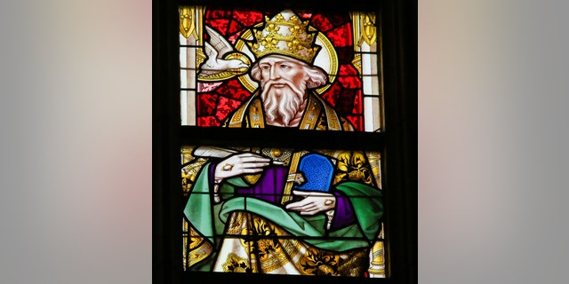 The Library of Congress says Pope Gregory, depicted here in a stained-glass portrait, declared that all who sneeze require a blessing.