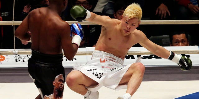 Japanese kickboxer Tenshin Nasukawa lies on the mat after being knocked out by Floyd Mayweather Jr. during first round of their three-round exhibition match on New Year's Eve, at Saitama Super Arena in Saitama, north of Tokyo.