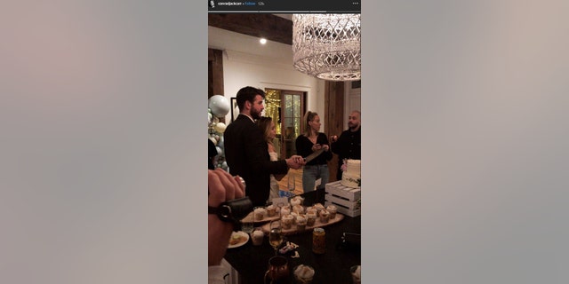 Photo of Miley Cyrus, Liam Hemsworth cutting apparent wedding cake ...