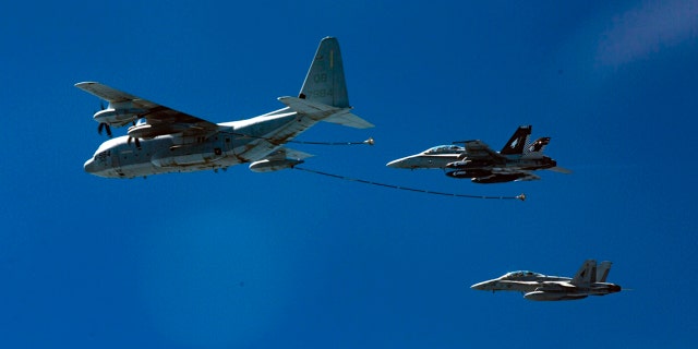 Two F/A-18D Hornets with Marine All-Weather Fighter Attack Squadron 533 approach a KC-130J with Marine Aerial Refueler Transport Squadron 352 during a Special Purpose Marine Air-Ground Task Force - Crisis Response - Central Command aerial refueling exercise in undisclosed location. (Cpl. Trever Statz/U.S. Marine Corps via AP)