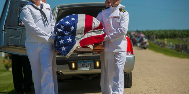 FILE - In this July 7, 2018 file photo, U.S. Navy sailors remove the casket with the remains of Seaman First Class Leon Arickx from a hearse at Sacred Heart Cemetery in Osage, Iowa. Arickx' remains, which were unidentifiable after his death after the Japanese attack at Pearl Harbor in 1941, were identified through DNA testing earlier this year. (Chris Zoeller/Globe-Gazette via AP, File)