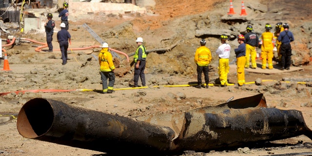 In this Sept. 11, 2010, file photo, a natural gas line lies broken on a San Bruno, Calif., road after a massive explosion. The California Public Utilities Commission said Friday, Dec. 14, 2018, that an investigation by its staff found Pacific Gas &amp; Electric Co. lacked enough employees to fulfill requests to find and mark natural gas pipelines(AP Photo/Noah Berger, File)