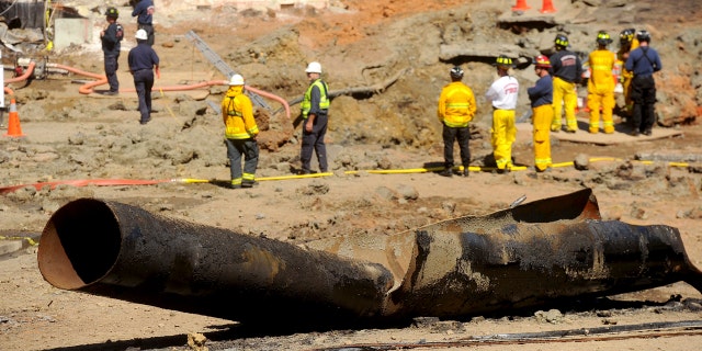 In this Sept. 11, 2010, file photo, a natural gas line lies broken on a San Bruno, Calif., road after a massive explosion. The California Public Utilities Commission said Friday, Dec. 14, 2018, that an investigation by its staff found Pacific Gas & Electric Co. lacked enough employees to fulfill requests to find and mark natural gas pipelines(AP Photo/Noah Berger, File)
