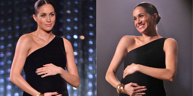 Meghan Markle cradles her baby bump at the 2018 British Fashion Awards.