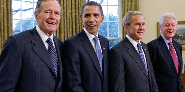 Former President George H.W. Bush, left, joins then President-elect Barack Obama, President George W. Bush, former President Bill Clinton and former President Jimmy Carter in the Oval Office in 2009. (AP Photo/J. Scott Applewhite, file)