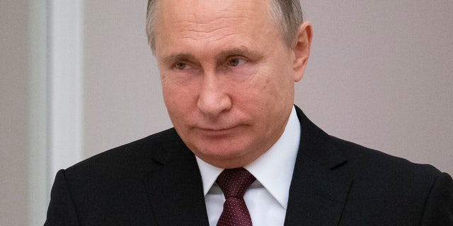 Russian President Vladimir Putin arrives to chair a meeting to discuss preparation to mark the anniversary of the allied victory in the World War II in the Kremlin in Moscow, Russia, Wednesday, Dec. 12, 2018.