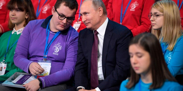 Russian President Vladimir Putin, center, attends a high-tech forum for youth in Yaroslavl, Russia, Thursday, Dec. 13, 2018.