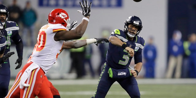 Seattle Seahawks quarterback Russell Wilson (3) passes under pressure from Kansas City Chiefs outside linebacker Justin Houston, left, during the second half of an NFL football game, Sunday, Dec. 23, 2018, in Seattle. (Associated Press)