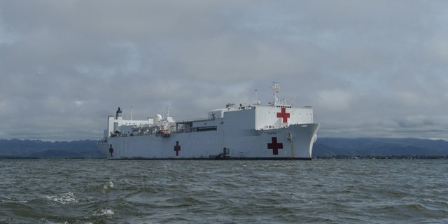 The hospital ship USNS Comfort (T-AH 20) is anchored off the coast of Colombia to offer medical treatment aboard the ship and at a land-based medical site.