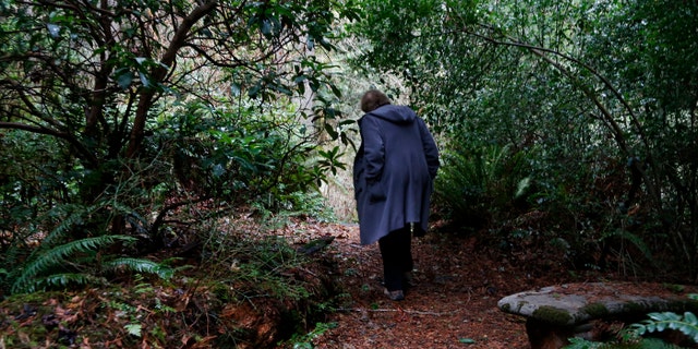 In this Monday, Dec. 10, 2018, photo, Psychologist Hilarie Cash walks on a forest path at a rehab center for adolescents in a rural area outside Redmond, Wash. The complex is part of reSTART Life, a residential program for adolescents and adults who have serious issues with excessive tech use, including video games. Disconnecting from tech and getting outside is part of the rehabilitation process. (AP)