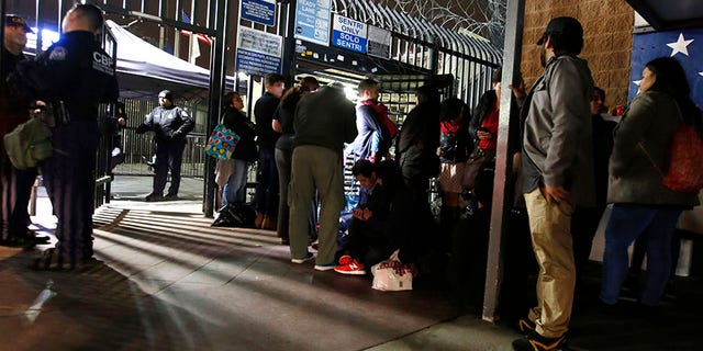 Activists for migrant rights surround a group of Honduran asylum seekers camped on U.S. soil at San Diego's Otay Mesa port of entry, seen from Tijuana, Mexico.