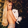 Paris Hilton went topless on Instagram to promote her denim line. The 36-year-old hotel heiress was posing with one of her many pups. For more photos of Hilton, visit HollywoodLife.com.