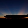 The sun rises behind Special Air Mission 41, the plane that will transfer the casket of former President George H.W. Bush to Washington, in Houston, Dec. 3, 2018. 