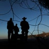 Border patrol officers stand at the beach on the U.S. side of the fence between San Diego and Tijuana, Mexico, Dec. 24, 2018. 