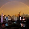 A double rainbow arches over downtown at the Obelisk where River Plate soccer fans celebrate their team's defeating Boca Juniors 3-1 and the clenching of the Copa Libertadores championship title, in Buenos Aires, Argentina, Dec. 9, 2018.  