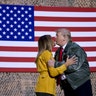 President Donald Trump kisses first lady Melania Trump during a hanger rally at Al Asad Air Base, Iraq, Dec. 26, 2018. 
