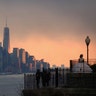 A bride poses for pictures in front of the skyline of lower Manhattan in New York City as seen from Weehawken, N.J., Dec. 8, 2018